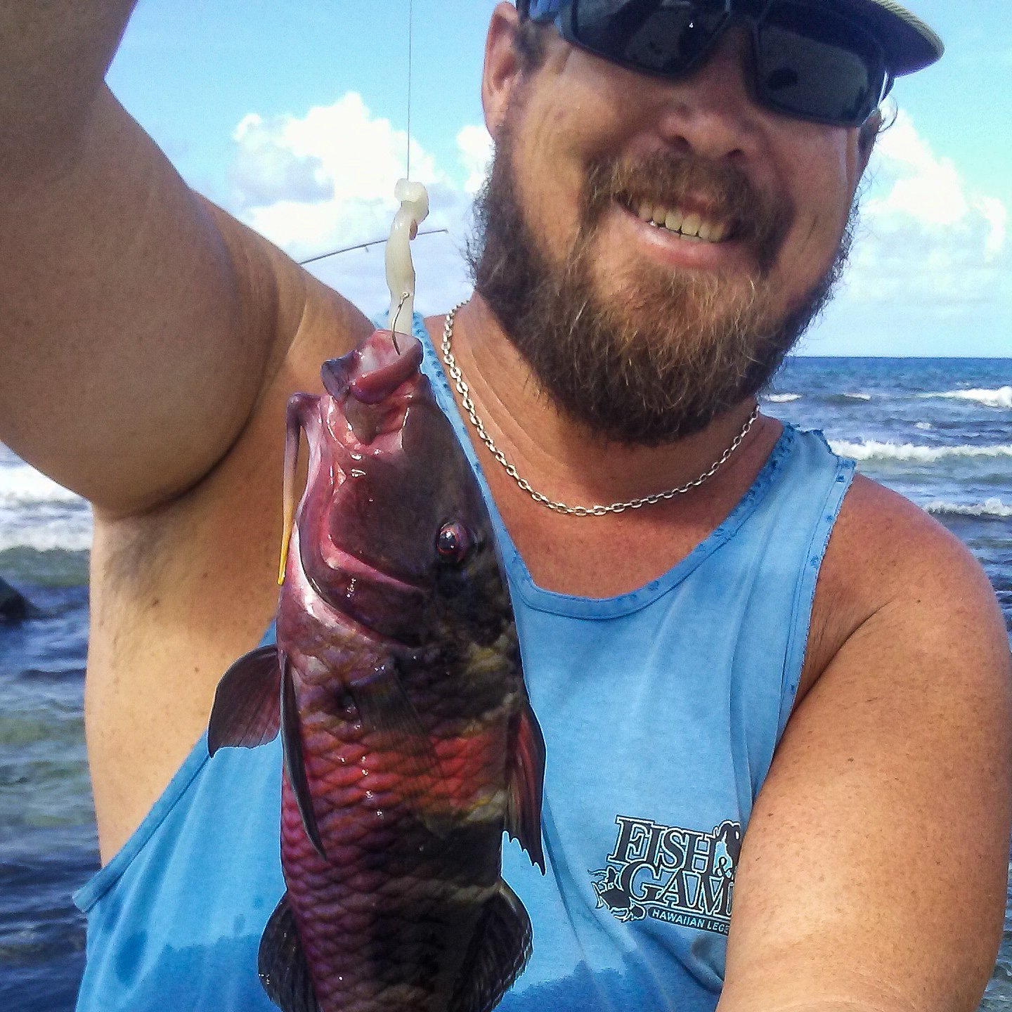 man holding a red fish