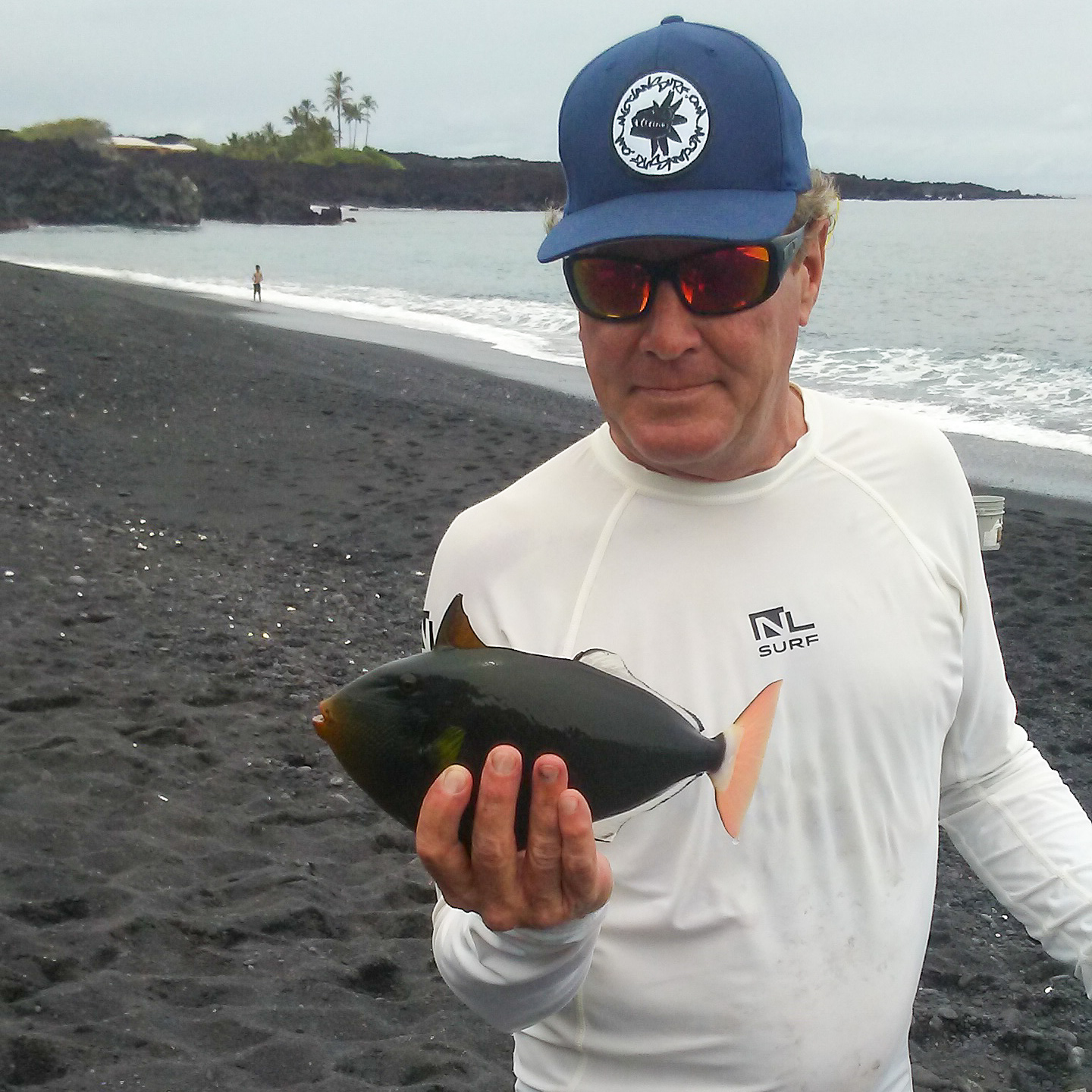 man holding a black fish