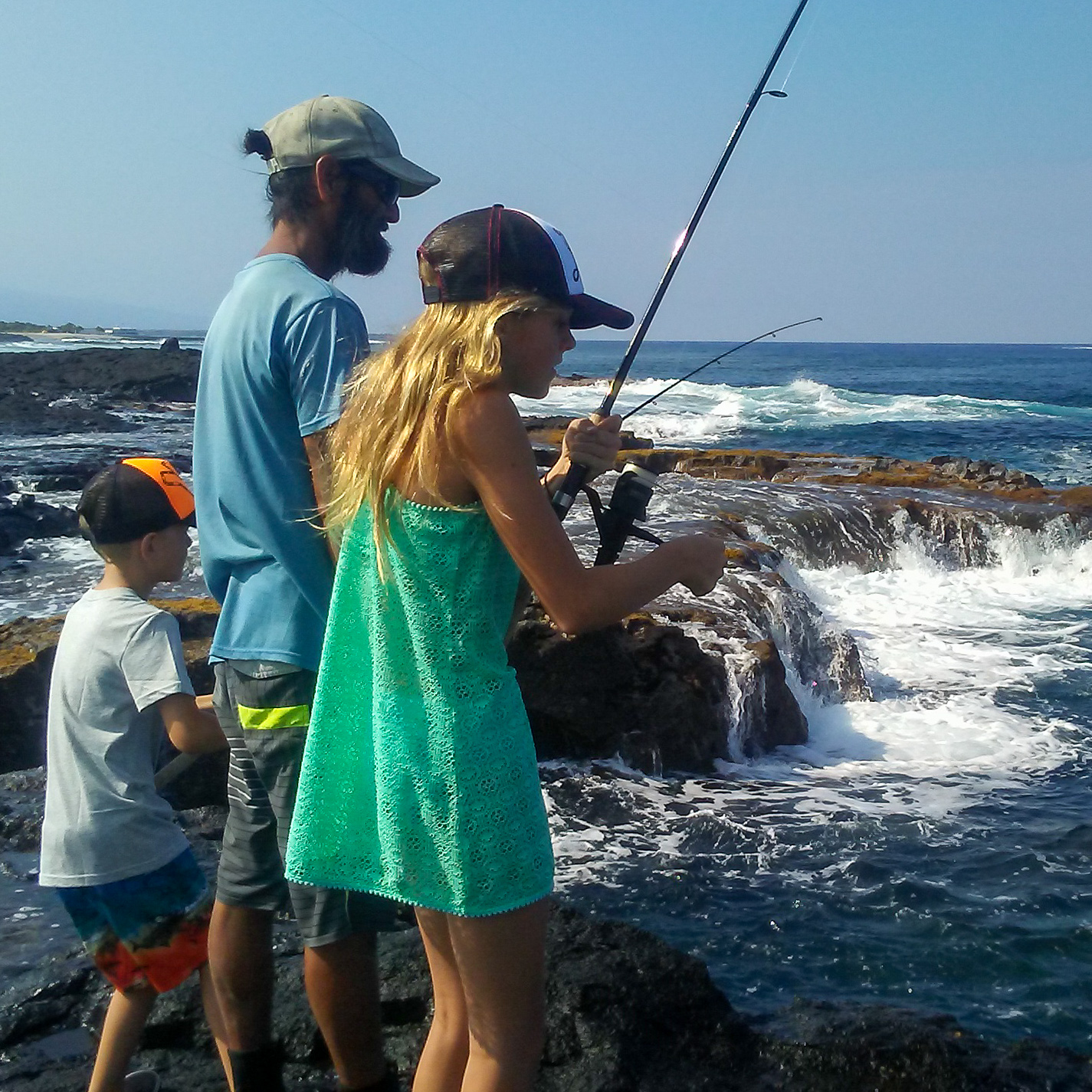 man and kids fishing in Hawaii